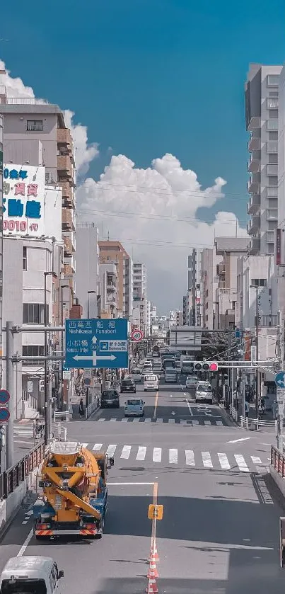 Urban city street with tall buildings under a blue sky.