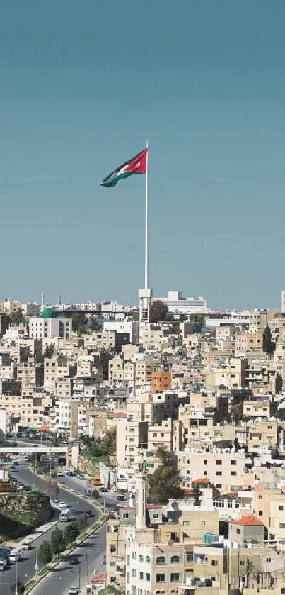 Aerial view of cityscape with a flag on a clear blue sky.