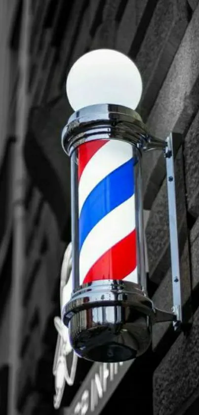 Classic barber pole with red, white, and blue stripes on a brick wall.