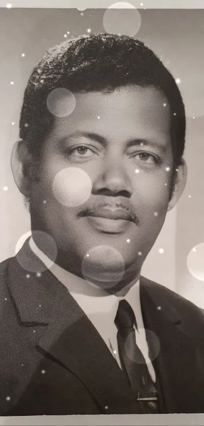 Black and white portrait of a gentleman in a suit, showcasing timeless elegance.