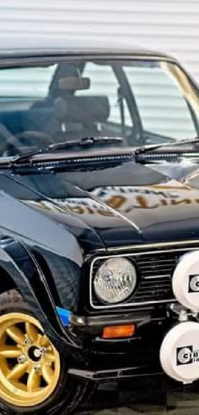 Classic black car with golden wheels parked indoors.