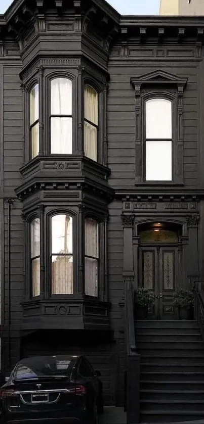 Wallpaper of a classic black Victorian house facade.