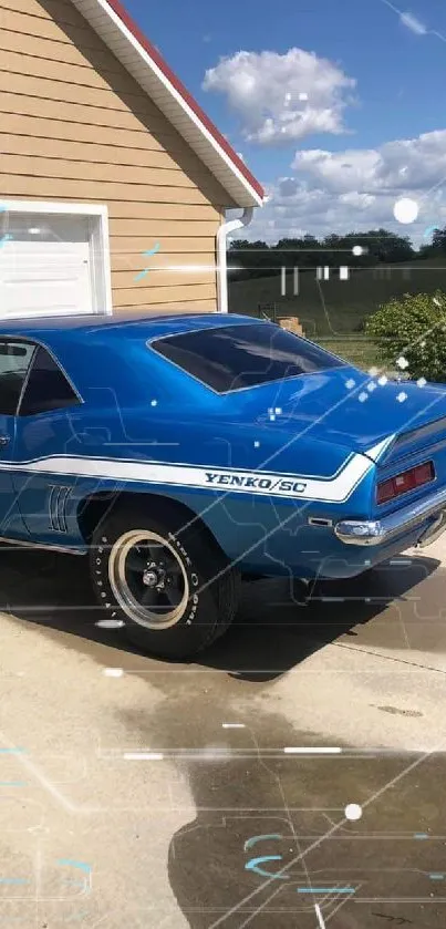 Classic blue muscle car parked outside a house on a sunny day.