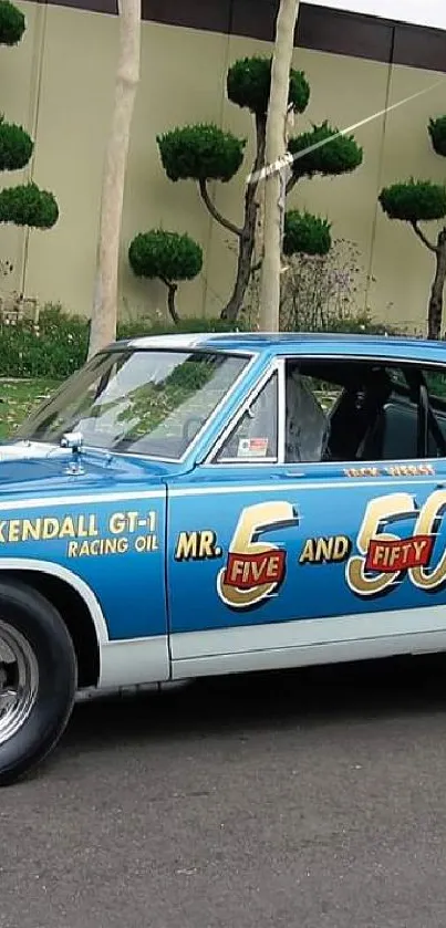 Vintage blue racing car with decals and classic design on the road.