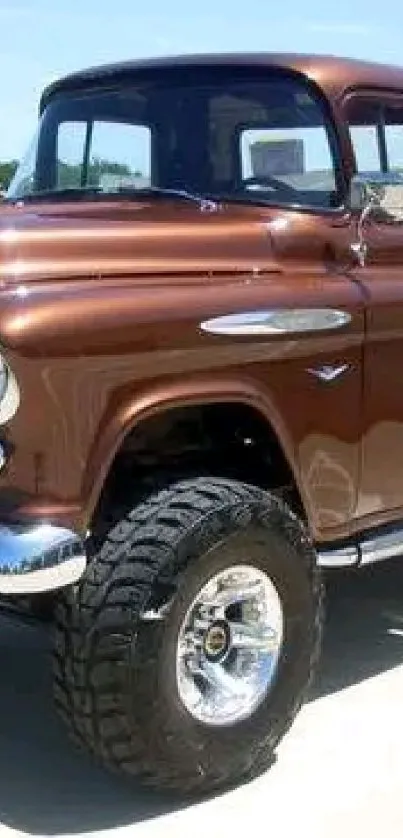 Brown vintage pickup truck parked outdoors in sunny setting.