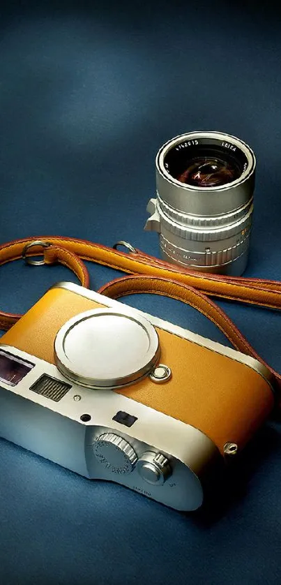 Vintage camera and lens on dark blue background with brown strap.