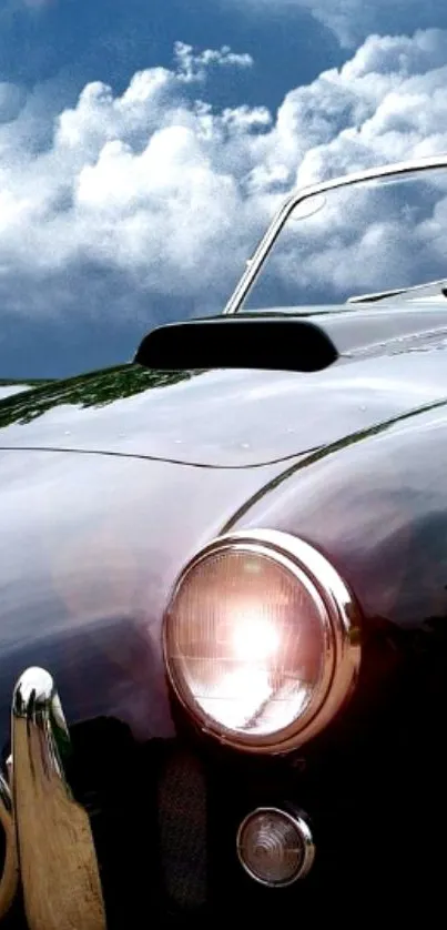 Vintage car against a cloudy sky backdrop, showcasing elegance.