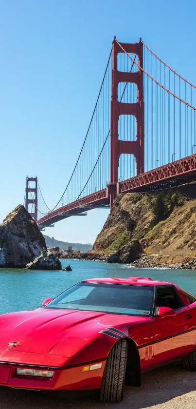 Red sports car by the Golden Gate Bridge and blue sky.