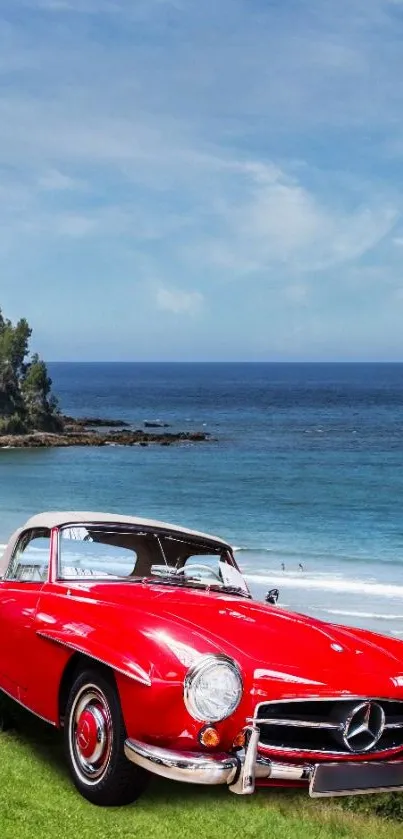 Classic red car on grassy beach with ocean view.