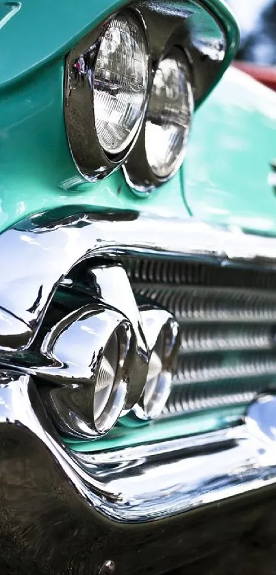 Close-up of a classic car's chrome front bumper and headlights.