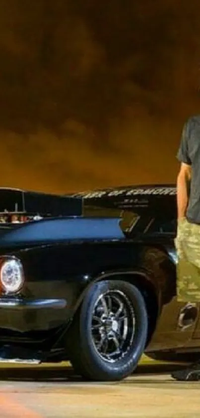 Man stands beside classic black car at night.