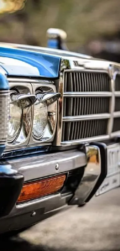 Close-up of a classic car front with detailed chrome and vibrant blue color.