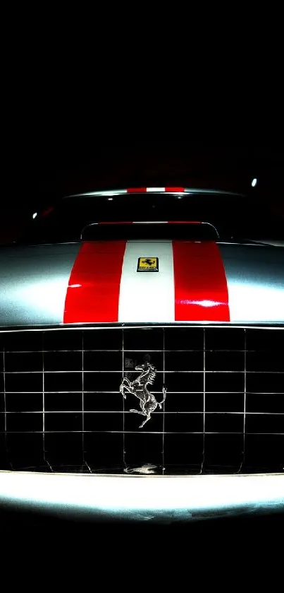 Classic car front view with striking headlights and red racing stripe.