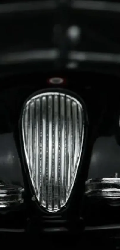 Close-up of a classic car grille with chrome detailing.