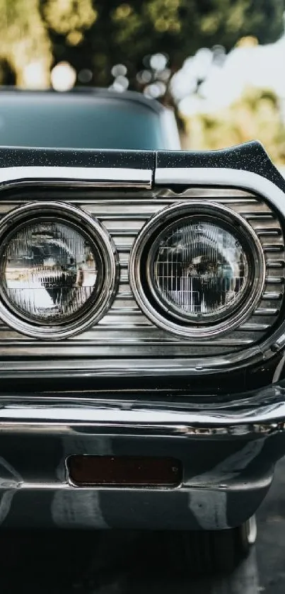 Close-up of a vintage car with chrome detailing and a blurred background.