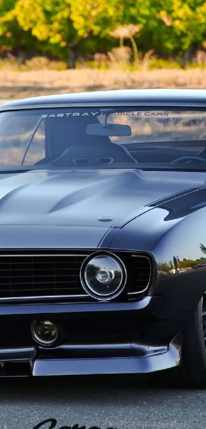 Sleek black vintage car parked outdoors, perfect for wallpapers.