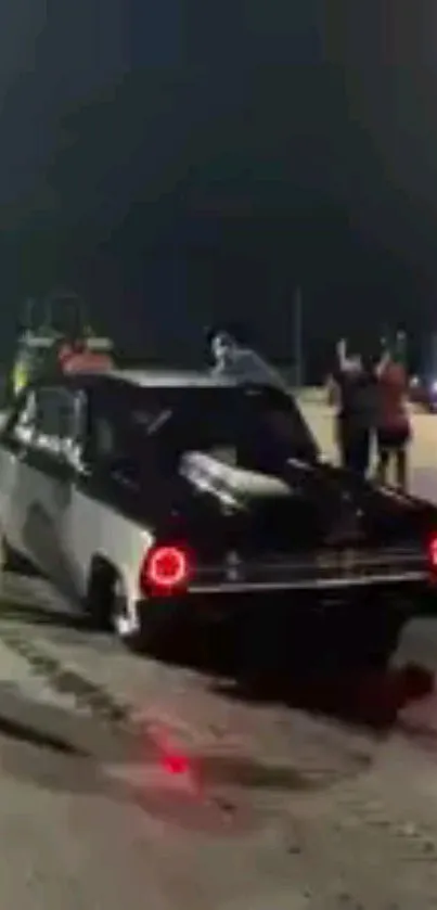 Classic car burn out at night on track.