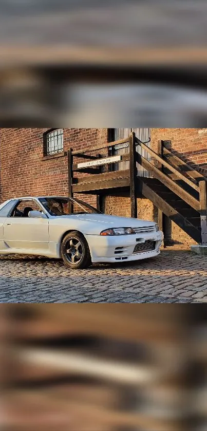 Vintage car parked on cobblestone with brick background.