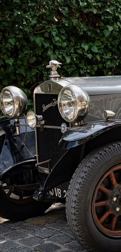 Classic vintage car parked on cobblestone street.