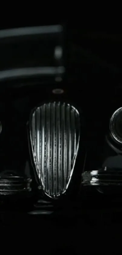 Front view of a classic car with black background, emphasizing elegance.