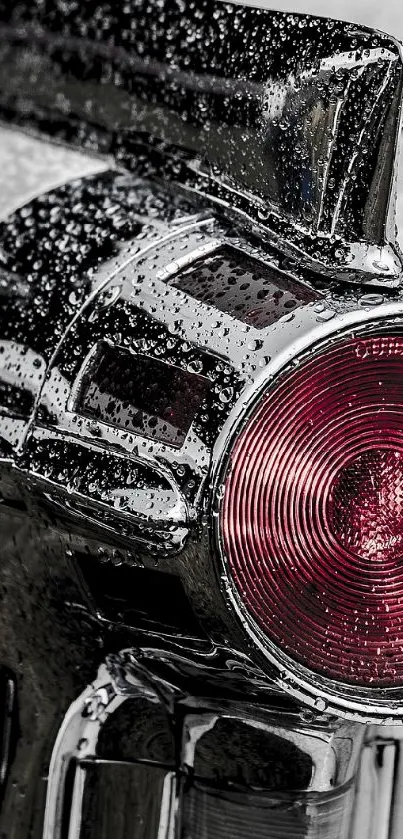 Close-up of classic car chrome tail light with rain droplets.