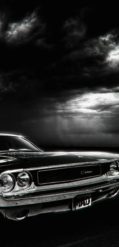 Black and white wallpaper of a classic car under a stormy sky.