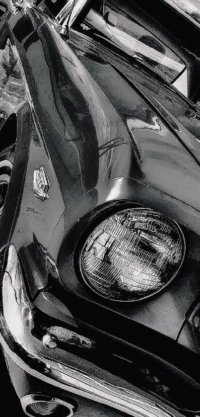 Close-up of a vintage car in black and white, showcasing classic design.