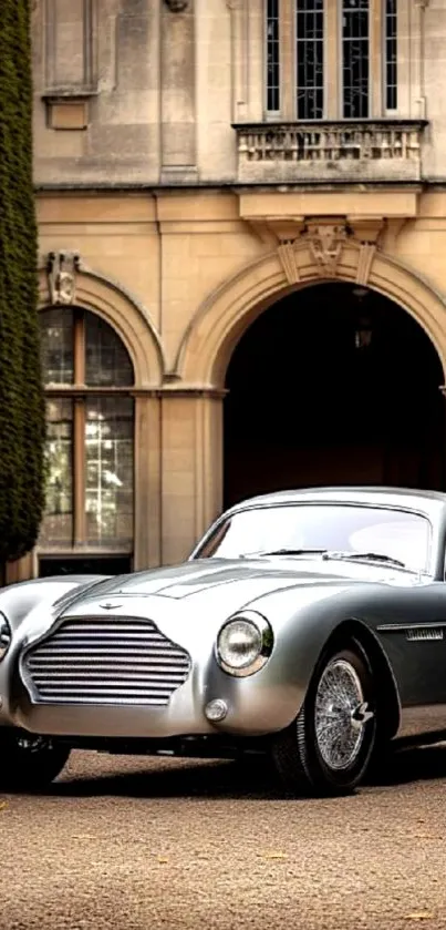 Elegant silver vintage car parked in front of a historic building.