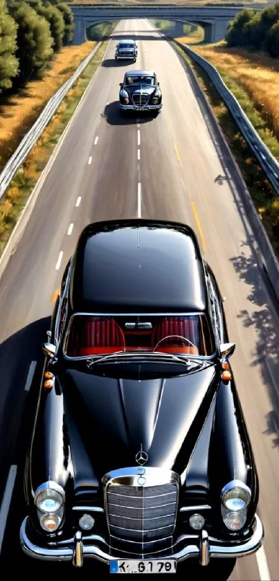 Black classic cars on an open highway under clear skies.