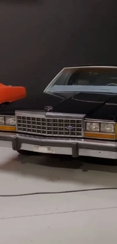 Classic cars in a modern showroom featuring a black and orange vehicle.