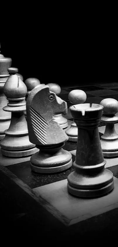 Monochrome chess set displaying strategic pieces on a board.