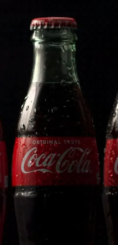 Classic Coca-Cola bottle on dark background with reflective surface.