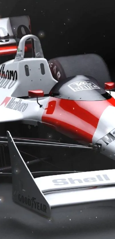 Classic Formula 1 car in red and white on a black background.