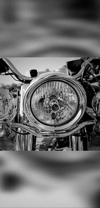 Black and white close-up of a classic motorcycle headlight.