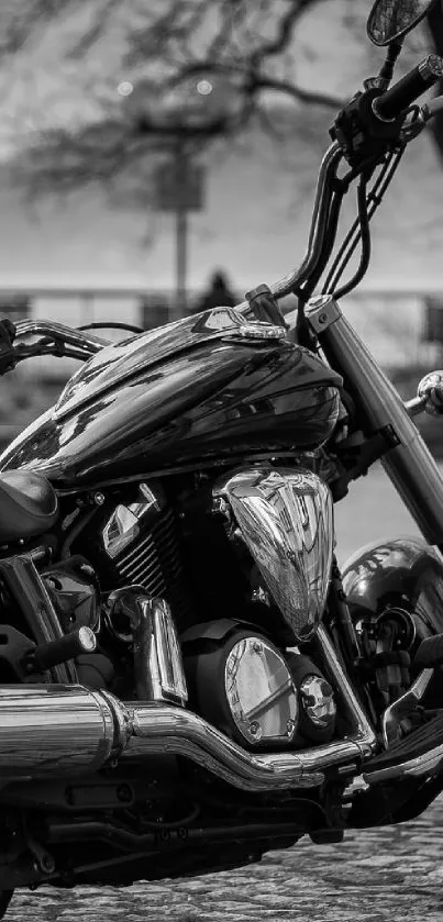 Monochrome image of a classic motorcycle in an urban setting.