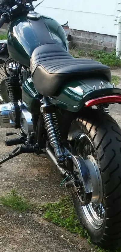 Rear view of a vintage motorcycle with dark green body and detailed design.