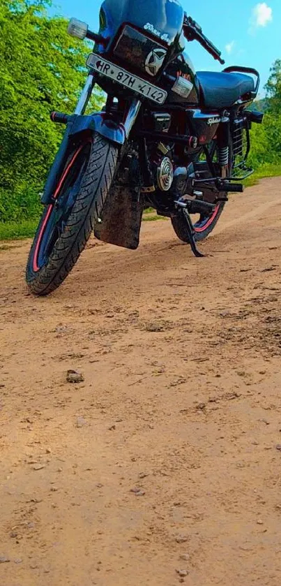 Classic motorcycle on a scenic dirt road with lush green surroundings.