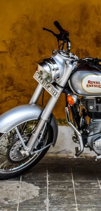 Classic Royal Enfield motorcycle against a vintage yellow background.