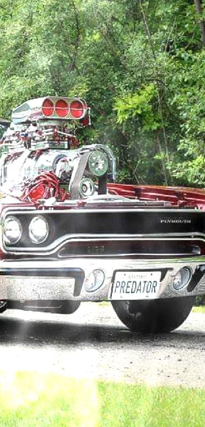 Classic red muscle car parked on a lush green lawn.