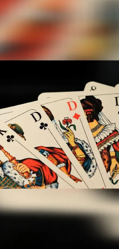 A set of detailed playing cards fanned out, featuring kings and queens.