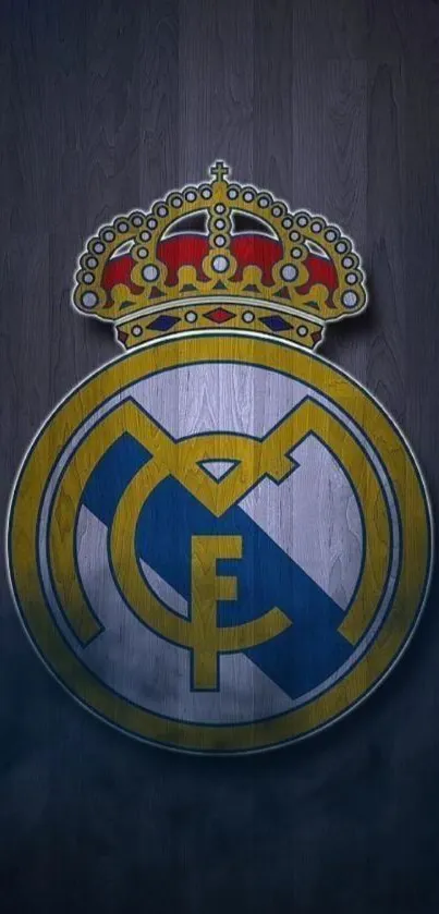 Real Madrid emblem on wooden background.