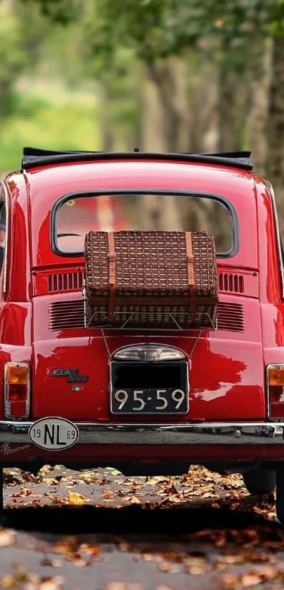 Vintage red car on forest road mobile wallpaper.