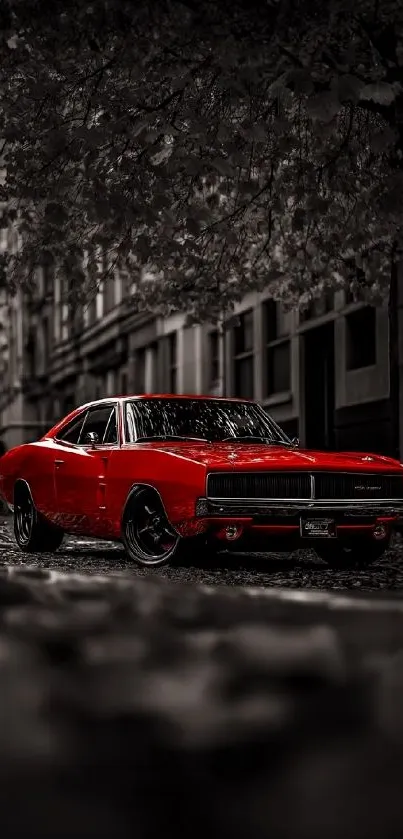 Red classic car on grayscale urban street.