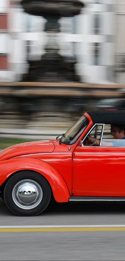 Red vintage convertible car speeding down a city street.