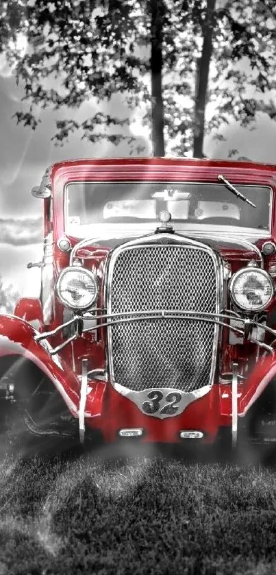 Vintage red car in a forest with monochrome background.