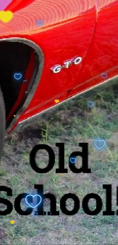 Bright red vintage car with 'Old School!' text on a grassy background.