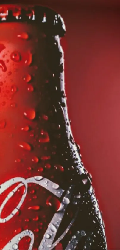 Red cola bottle with droplets on a vivid background.