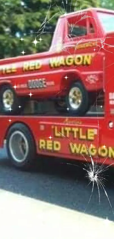 A classic red Dodge truck carrying another red pickup with 'Little Red Wagon' text.