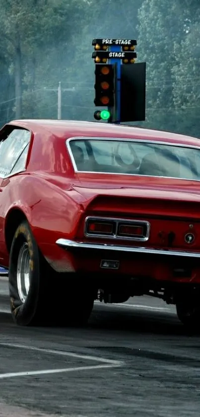 Red muscle car on drag strip wallpaper.