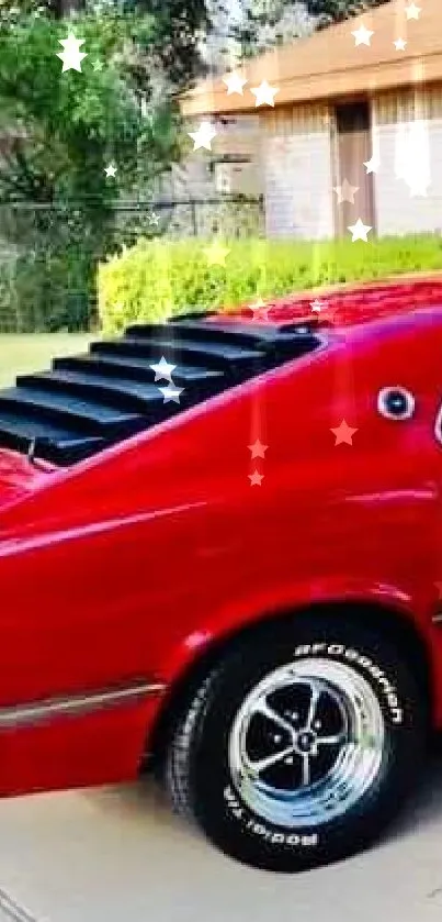 Classic red muscle car parked in driveway.